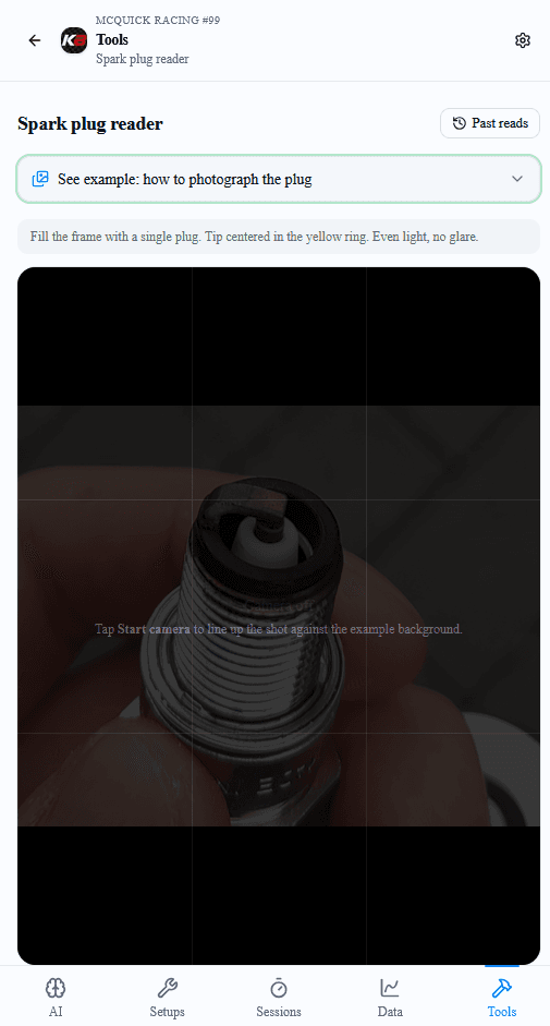 Spark plug reader before the camera starts. A dim example shows a plug held in fingers, and the instructions say to fill the frame with one plug, center the tip, and use even light with no glare.